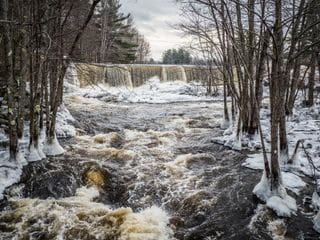 Scenic view of river flowing in forest during winter, Peterborough, New Hampshire.